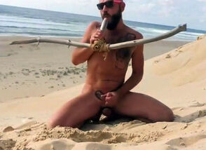 man nails himself on the beach